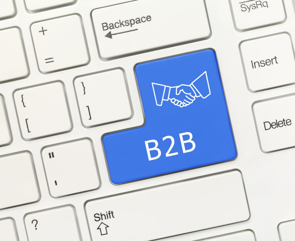 Tastatur anstelle der Entertaste ist eine blaue Taste mit B2B und einem Händeschlag