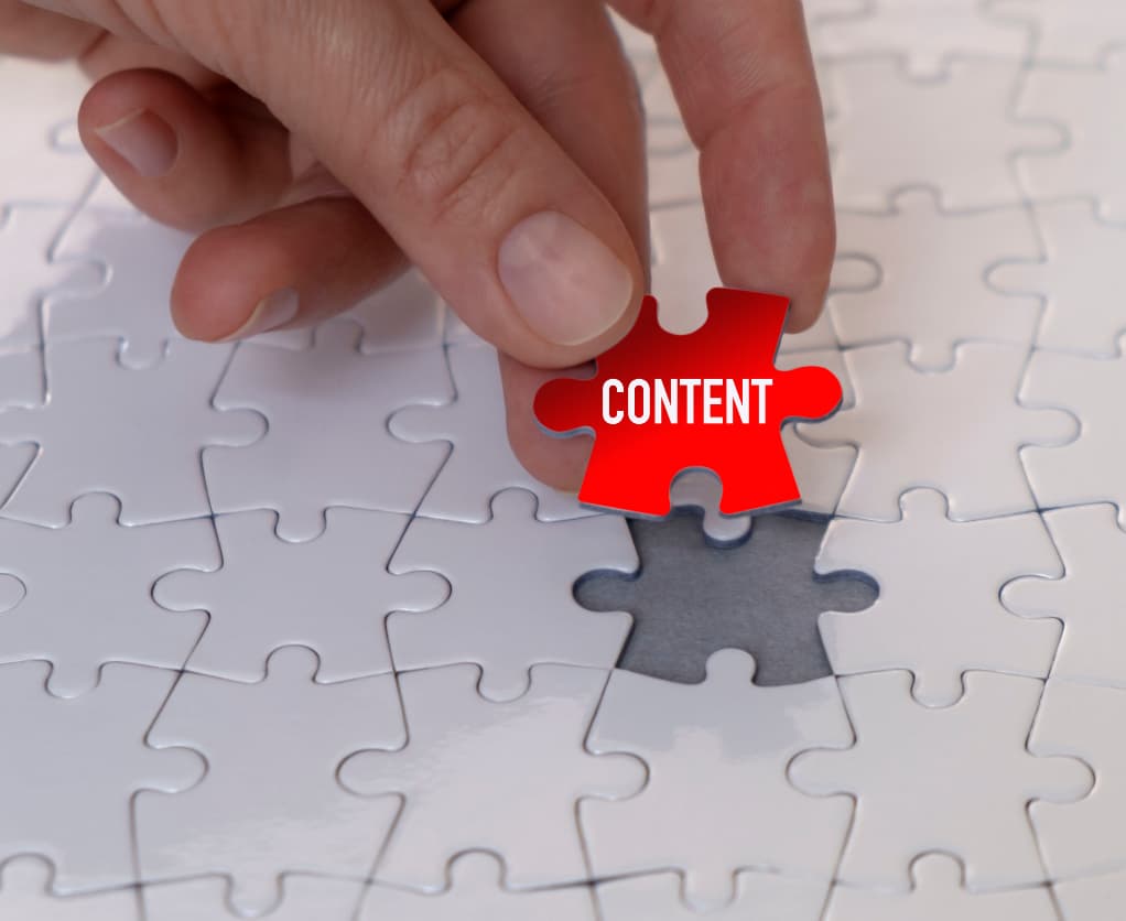 Puzzle mit rotem Puzzleteil "Content"